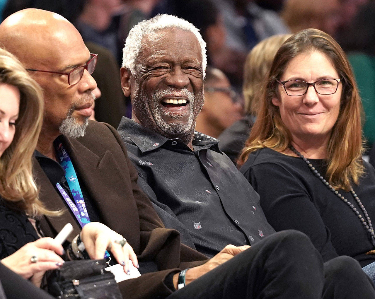 NBA legend Bill Russell smiles at others along courtside during the NBA All-Star Saturday Night festivities at Spectrum Center in Charlotte, N.C., on Saturday, Feb. 16, 2019. (Jeff Siner/Charlotte Observer/TNS)