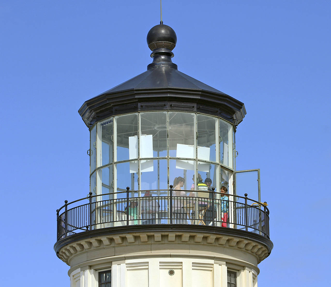 On a clear day, the view is worth the climb. In the observation room of the North Head Lighthouse in Ilwaco, visitors point to sights and wave at family members below.