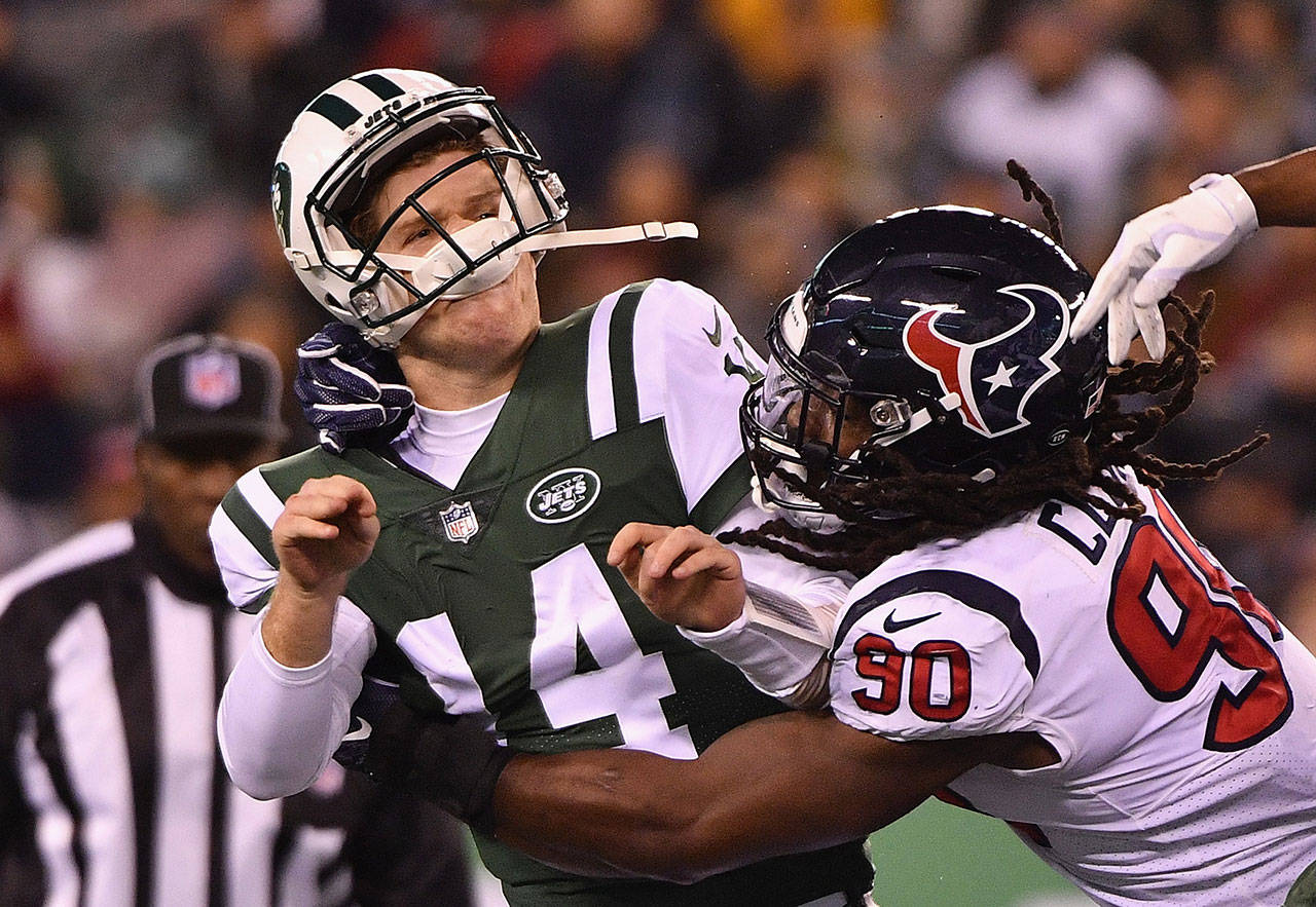 Former Houston Texans outside linebacker Jadeveon Clowney (90) hits New York Jets quarterback Sam Darnold during the second quarter at MetLife Stadium on December 15, 2018 in East Rutherford, New Jersey. Clowney was traded to the Seahawks on Saturday. (Mark Brown/Getty Images/TNS)