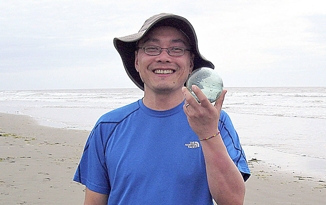 COURTESY JEFF AND MARIANNE PENCE                                Kentaro Urata of Kirkland found this hand-blown glass Japanese fishing float near Westport. Westport South Beach Historical Society members Jeff and Marianne Pence saw him with the float and snapped the picture.