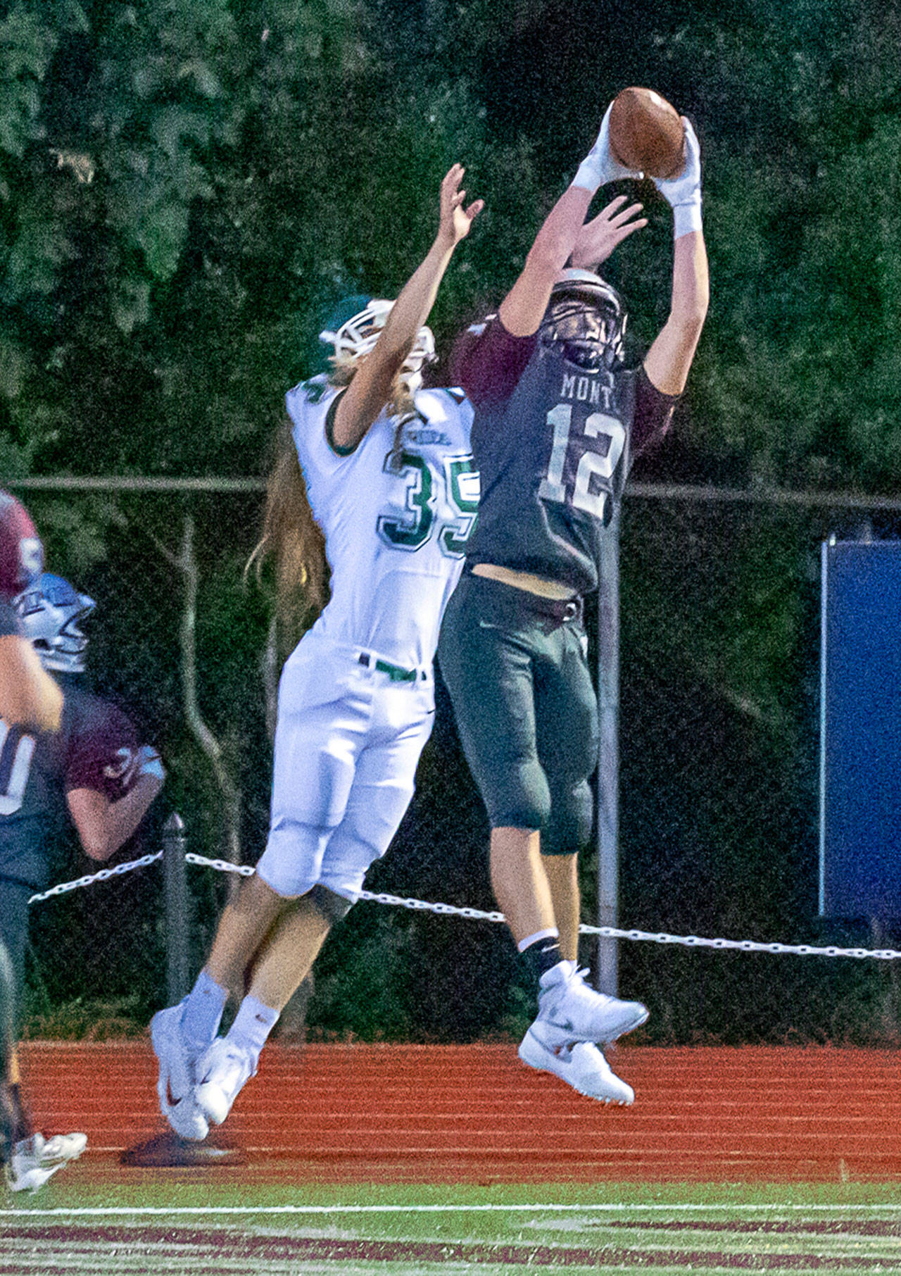 Montesanos Sam Winter (12) intercepts a pass against Port Angeles recevier Derek Bowechop during the Bulldogs 70-12 rout of the Roughriders on Friday at Jack Rottle Field in Montesano. (Hasani Grayson | Grays Harbor News Group)