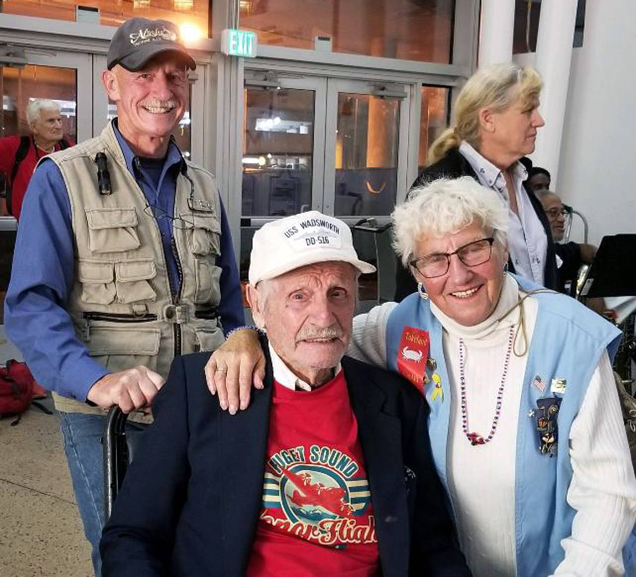 Photo courtesy O’Hagan family                                Family members Daniel O’Hagan, left, and Jenny Vinson greeted John O’Hagan, seated, after his Honor Flight.