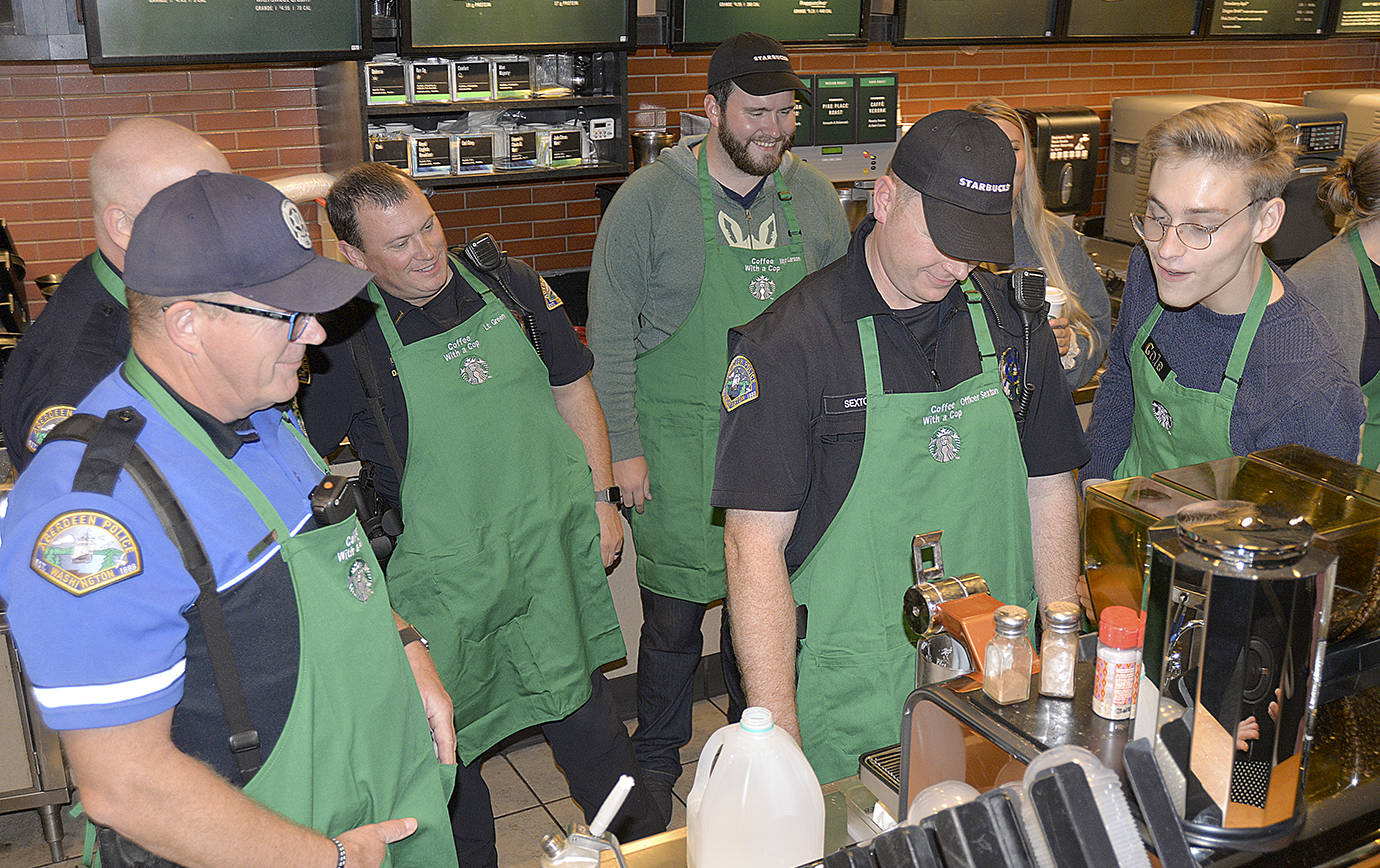 Cole Streeter, right, gave a crash course in latte-making at the Aberdeen Coffee with a Cop event. From left are Officer George Kelly, Lt. Dale Green, Aberdeen Mayor Erik Larson and Officer Gary Sexton.