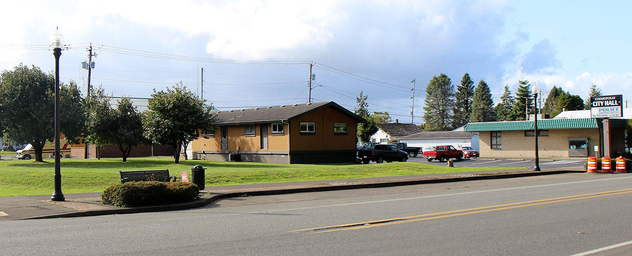 A new Cosmopolis Police Station would be in the field at left, seen here Tuesday, Oct. 8, 2019. At right is the former bank building that houses the City Hall. In the center is the mobile building that houses the city’s Police Station, which was built in 1971. (Michael Lang | Grays Harbor News Group)