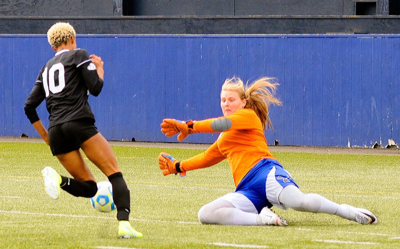 Grays Harbor’s Kristi Raffelson dives to make a save on Highline’s Hannah Jenkins on a breakaway in the second half at Stewart Field in Aberdeen on Saturday. (Hasani Grayson | Grays Harbor News Group)
