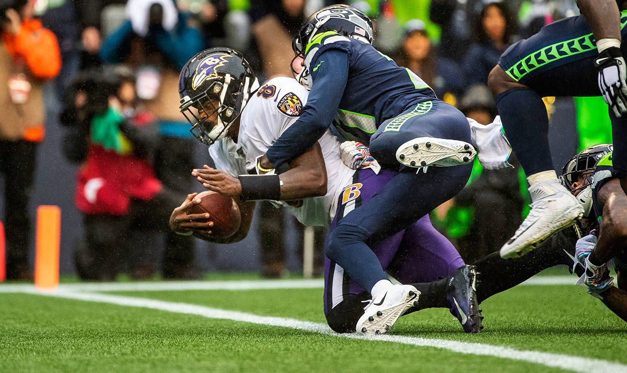Seattle Seahawks cornerback Tre Flowers can’t keep Baltimore Ravens quarterback Lamar Jackson from the end zone, scoring on an 8-yard run in the third quarter on Sunday, Oct. 20, 2019 at CenturyLink Field in Seattle, Wash. (Dean Rutz/Seattle Times/TNS)