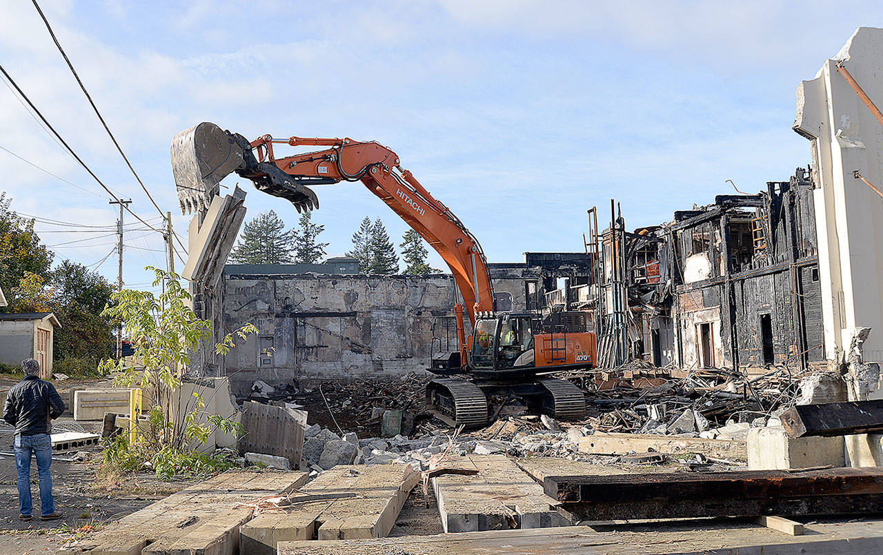 DAN HAMMOCK | GRAYS HARBOR NEWS GROUP                                Crews from Rognlin’s tear down the southeast walls of the Aberdeen Armory building on East Third Street in Aberdeen Monday morning. The building, which burned June 9, 2018, is the former home of the Aberdeen Museum of History, the Coastal Community Action Program and a senior center.