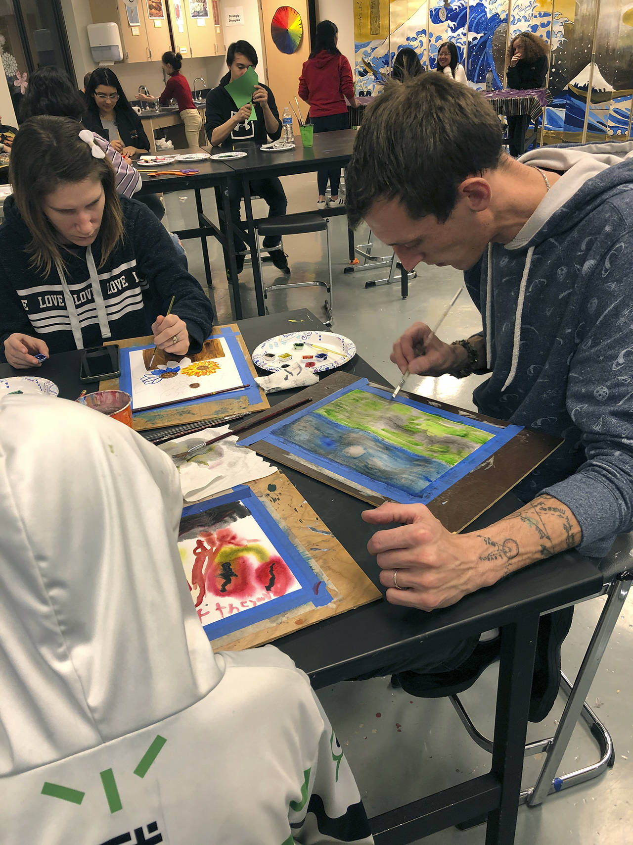 Courtesy photo                                James and Alyssa Lano, parents of art student Tegan Lano (foreground, in hoodie), experiment with watercolors.
