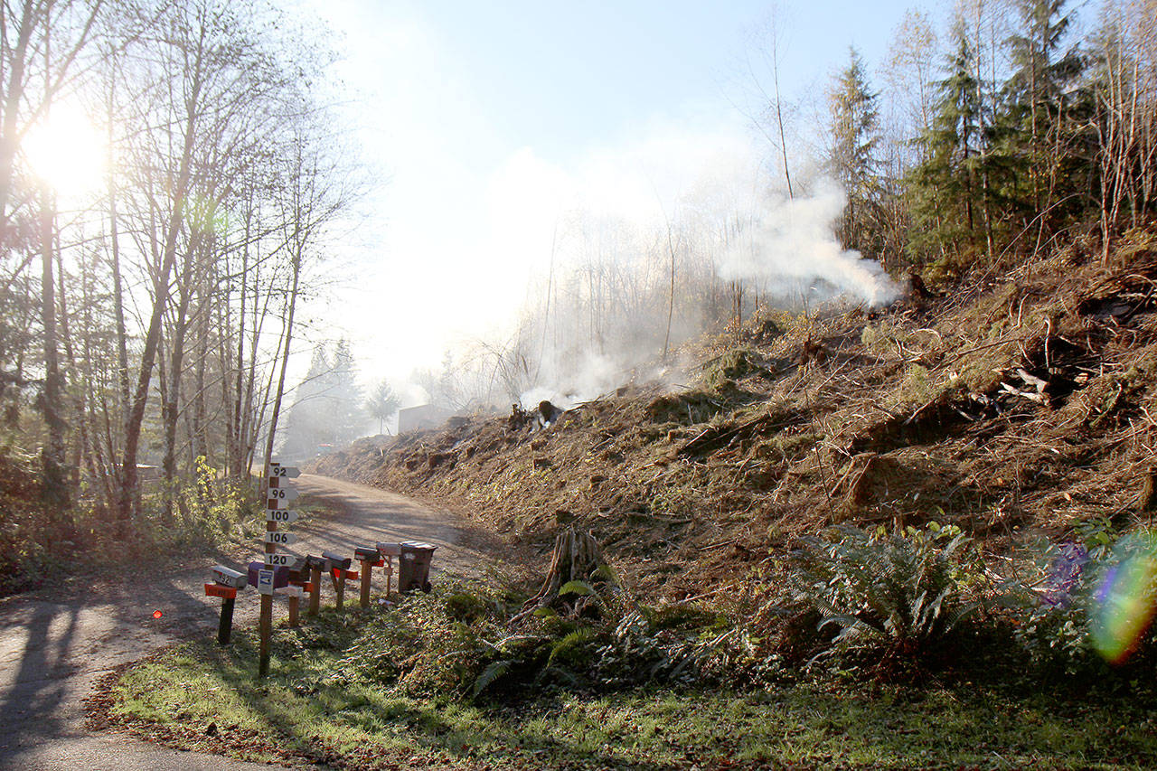 A fire smolders on a hillside while crews from Grays Harbor Fire District 2 try to knock it down Tuesday afternoon, Oct. 29, 2019, east of Montesano. By 10:30 a.m. Wednesday, the fire was 100 percent contained. Crews from four East County fire agencies were called in to help fight the blaze. (Michael Lang | Grays Harbor News Group)