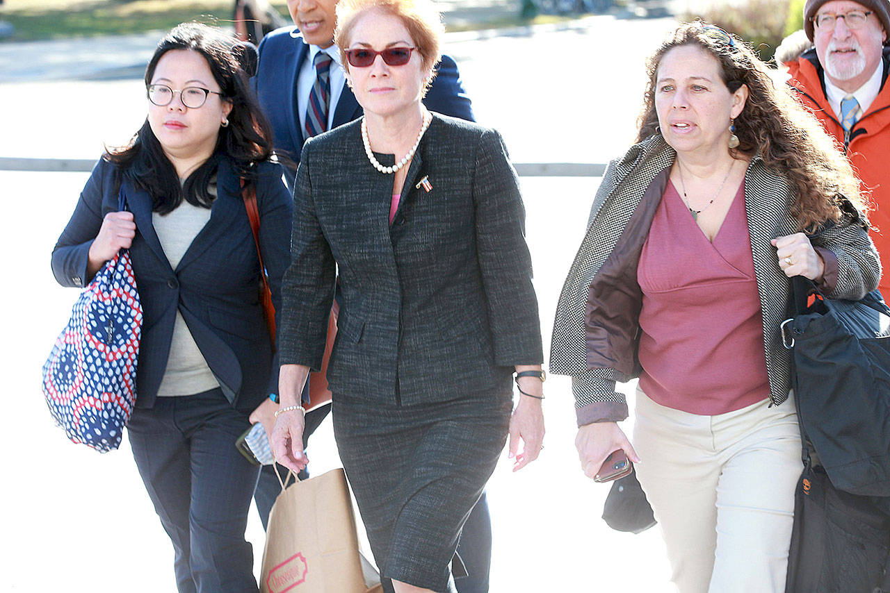 Marie Yovanovitch, center, the former U.S. ambassador to Ukraine, arrives on Capitol Hill on Friday, Oct. 11, to testify in the impeachment inquiry against President Trump. (Kirk McKoy/Los Angeles Times)
