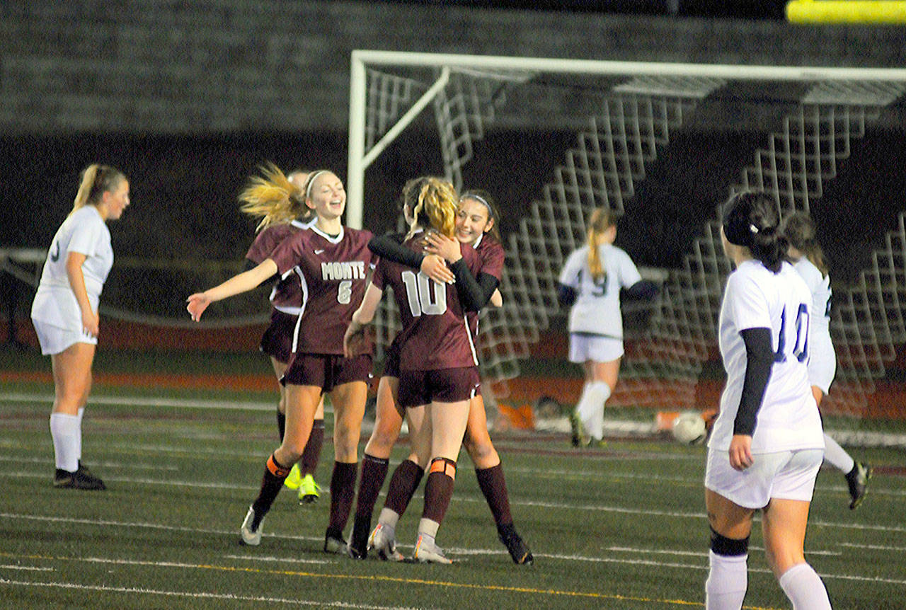 Montesano’s Jaiden Morrison gets a hug from Brooke Streeter (10) after scoring the first goal of the game in the 45th minute against King’s Way Christian on Tuesday in Montesano. (Hasani Grayson | Grays Harbor News Group)