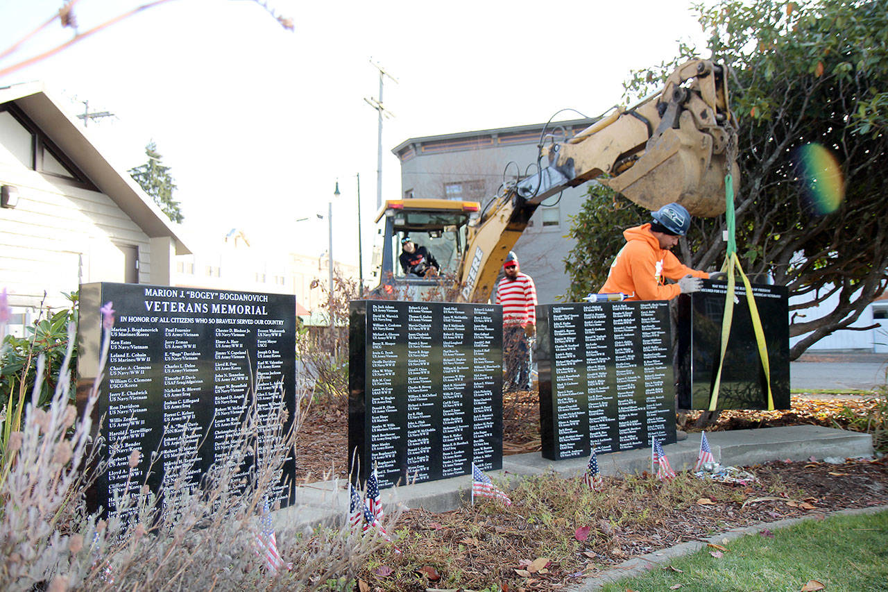 City of Montesano and Aberdeen Cemetery Association personnel add a fourth marble monument to the Marion J. “Bogey” Bogdanovich Veterans Honor Wall on Thursday, Oct. 31, 2019, at Fleet Park in Montesano. (Michael Lang | Grays Harbor News Group)