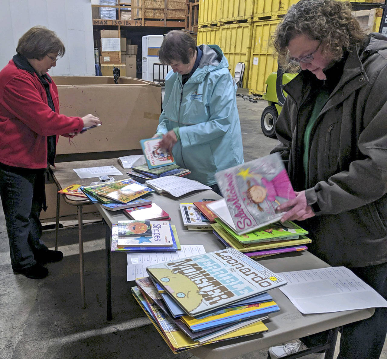Courtesy photo                                From left, Annette Biornstad, Jennifer Roetcisoen and Joan Julius review and label books for Altrusa International of Central Grays Harbor’s Little Red Book Shelf Project. The service organization places children’s books all over the Harbor for families to take home and read. (Current locations include Grays Harbor Community Hospital, the Domestic Violence Center of Grays Harbor, and the Grays Harbor County Public Health & Social Services Department offices.) The Altrusa International Foundation recently awarded a $2,000 grant to the local group to purchase shelves and over 1,700 new and used books.