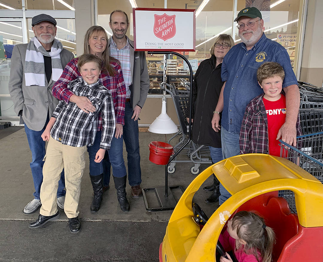 Kat Bryant | Grays Harbor News Group                                Four generations of bell-ringers, from left: John Beck, Carter Fuchs, Kim and Steve Fuchs, Kathy and Steve Beck, and Evan Fuchs. Nattie Mae Olive is in the toy car.