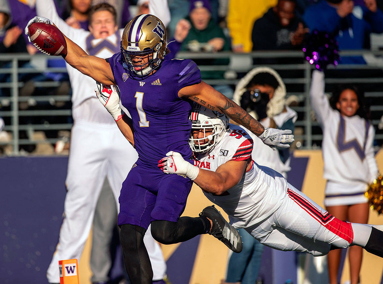 Washington’s Hunter Bryant (1) scores on a 40-yard touchdown pass in the third quarter, beating Utah’s Max Tupai to the end zone at Husky Stadium in Seattle on Saturday, Nov. 2, 2019. (Dean Rutz/Seattle Times/TNS)