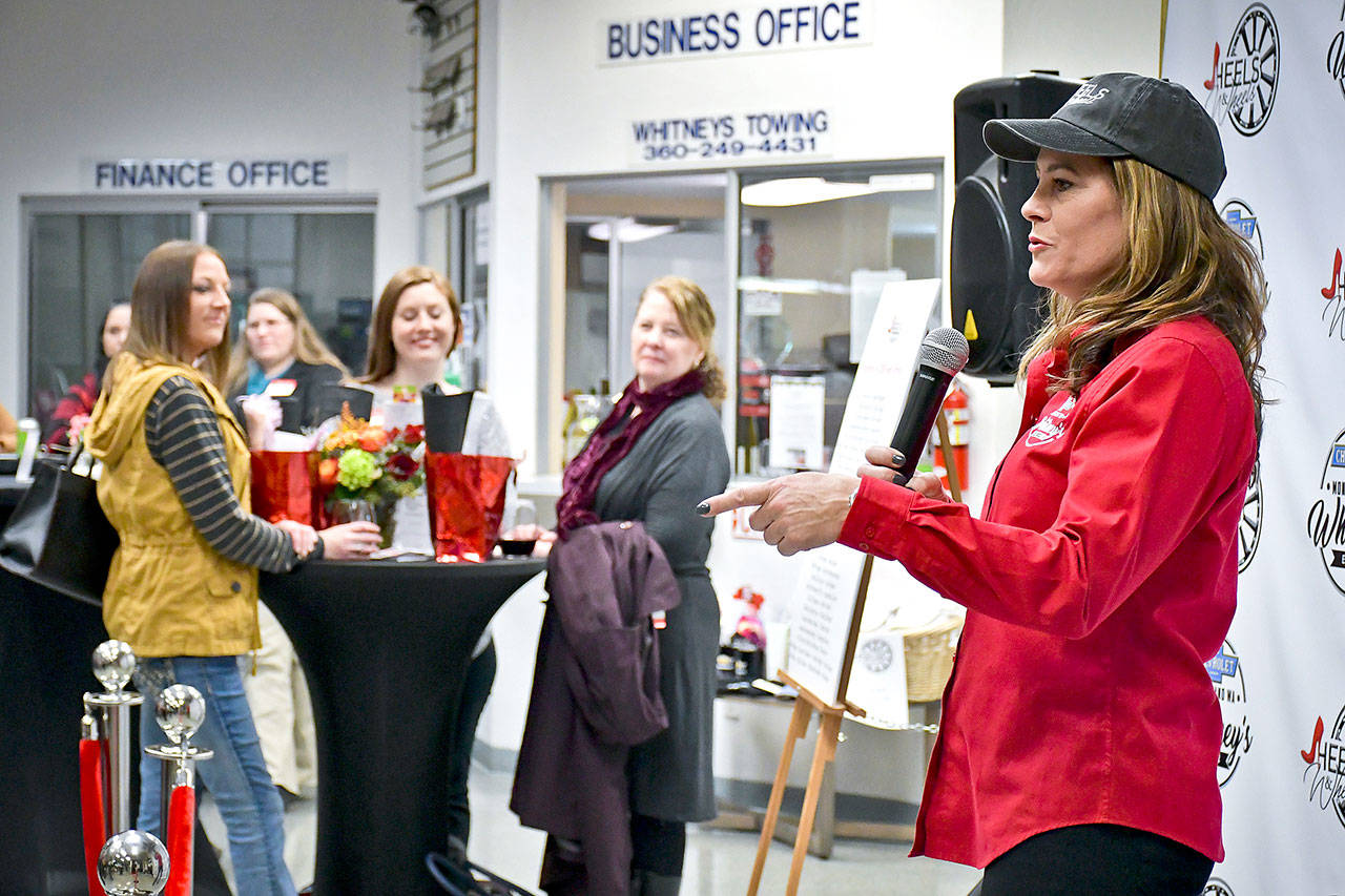 Photos by Darrell Westmoreland                                Michelle Glick, right, co-owner of Whitney’s Chevrolet in Montesano, welcomes about 50 women to the second Heels Wheels event last Thursday at the dealership. The women’s business networking event Heels Wheels started in May and the plan is for it to be repeated twice a year at Whitney’s Chevrolet, in the spring and fall.