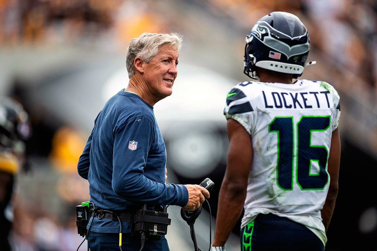 Pete Carroll talks to Tyler Lockett as the Seattle Seahawks wait for the officials to review defensive pass interference against the Seattle receiver in the fourth quarter against the Pittsburgh Steelers on Sunday, Sept. 15, 2019 at Heinz Field in Pittsburgh, Pa. (Dean Rutz/Seattle Times/TNS)