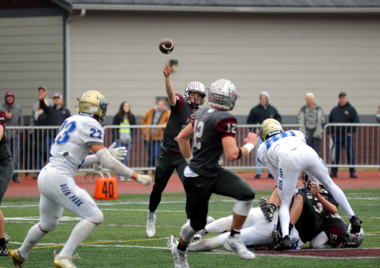 Montesano quarterback Trace Ridgway, background, wings a pass to receiver Sam Winter (12) in the first quarter of Montesano’s 20-17 loss in a 1A State Tournament quarterfinal game on Saturday at Jack Rottle Field in Montesano. (Ryan Sparks | Grays Harbor News Group)