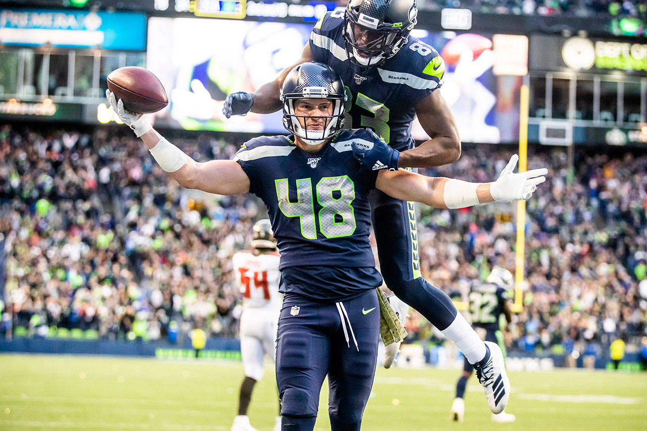 Seattle Seahawks tight end Jacob Hollister celebrates scoring the game-winning touchdown in overtime with Seahawks wide receiver David Moore on his back as the Seahawks defeat the Tampa Bay Buccaneers 40-34 on Sunday, Nov. 3, 2019 at CenturyLink Field in Seattle, Wash. (Mike Siegel/Seattle Times/TNS)