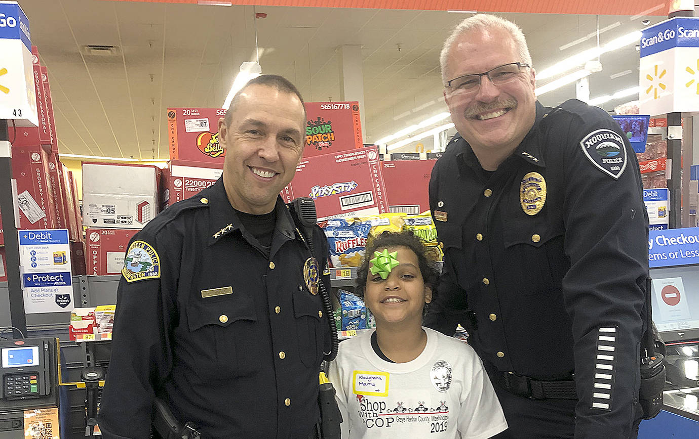 COURTESY HOQUIAM POLICE DEPARTMENT                                Aberdeen Police Chief Steve Shumate, left, and Hoquiam Police Chief Jeff Myers with a 2019 Shop with a Cop participant at the Walmart Saturday morning.