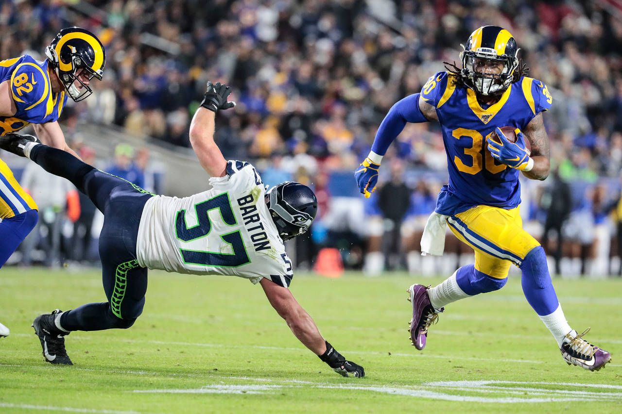 Los Angeles Rams running back Todd Gurley (30) turns the corner by Seattle Seahawks linebacker Cody Barton (57) during a second quarter touchdown drive on Sunday at LA Memorial Coliseum in Los Angeles, Calif. (Robert Gauthier | Los Angeles Times/TNS)