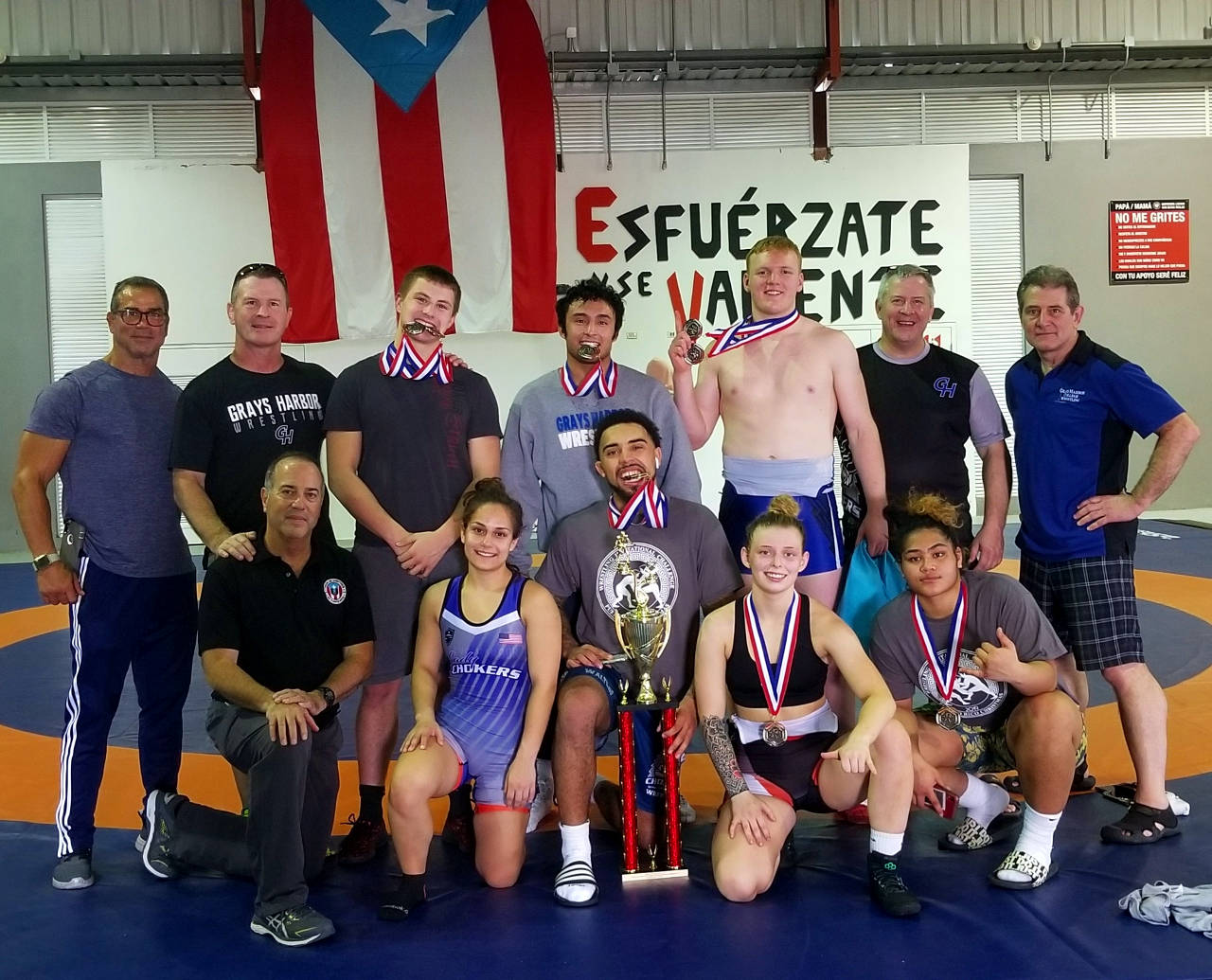 The Grays Harbor College wrestling team had multiple wrestlers place at a holiday tournament in San Juan, Puerto Rico over the weekend. Pictured are (front row, from left): PR Olympic referee Robert Lugo, Cynthia Diaz, Darrien Walters, Southern Oregon University’s (and future GHC wrestler) Kaylee Gaines and Sila Fotu, (back row) PR wrestling champion Jose Betancourt, GHC coach Kevin Pine, Eastern Washington’s Dalton Swayze, Andy Gonzales, Noah Winder, GHC coach Phillip Pine, GHC assistant coach Chris Boeger. (Submitted photo)