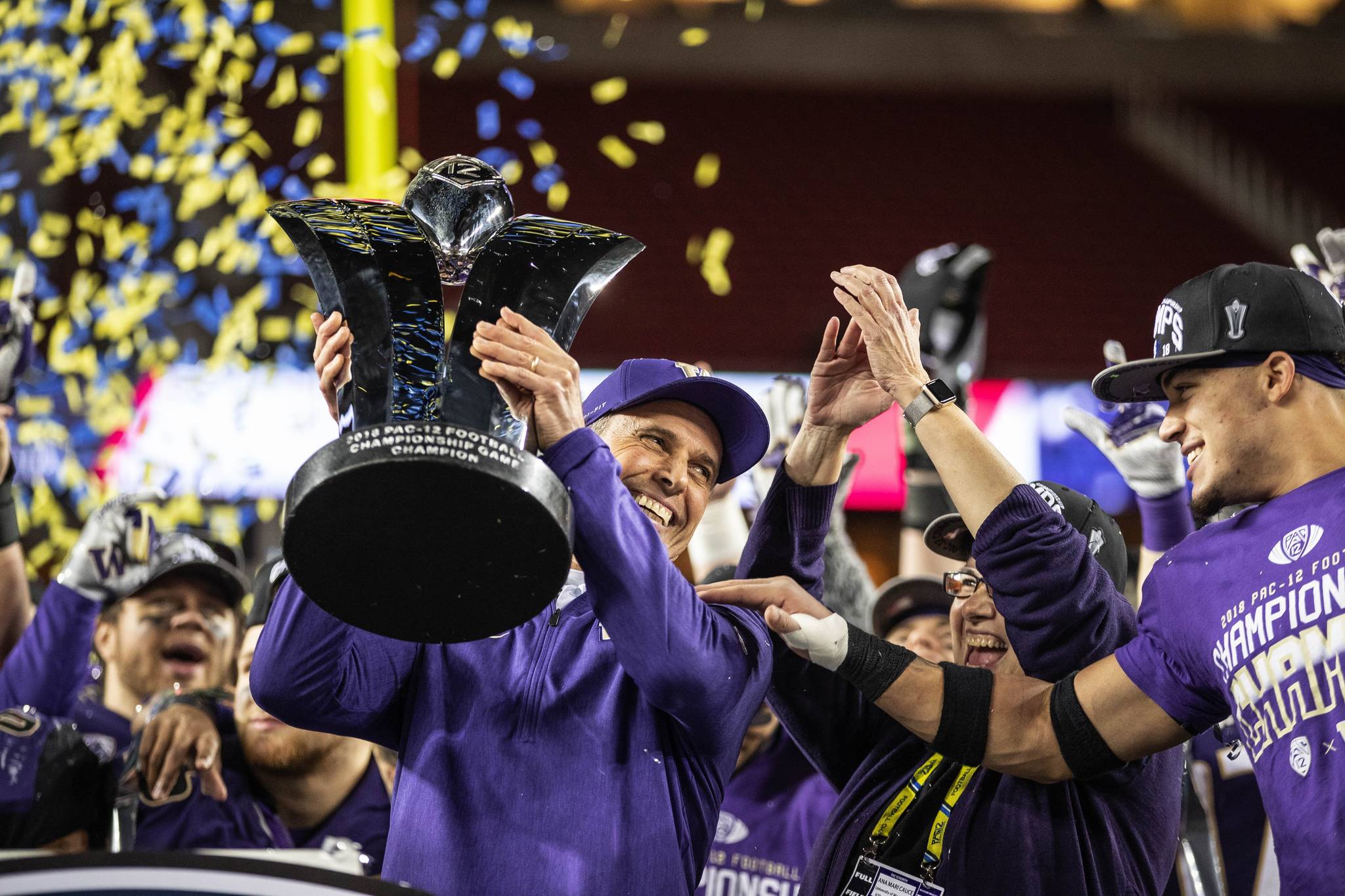 Dean Rutz | Seattle Times/TNS                                 Chris Petersen hoists the Pac-12 Championship trophy, with MVP Byron Murphy at right Friday, Nov. 30, 2018 in Santa Clara, Calif.