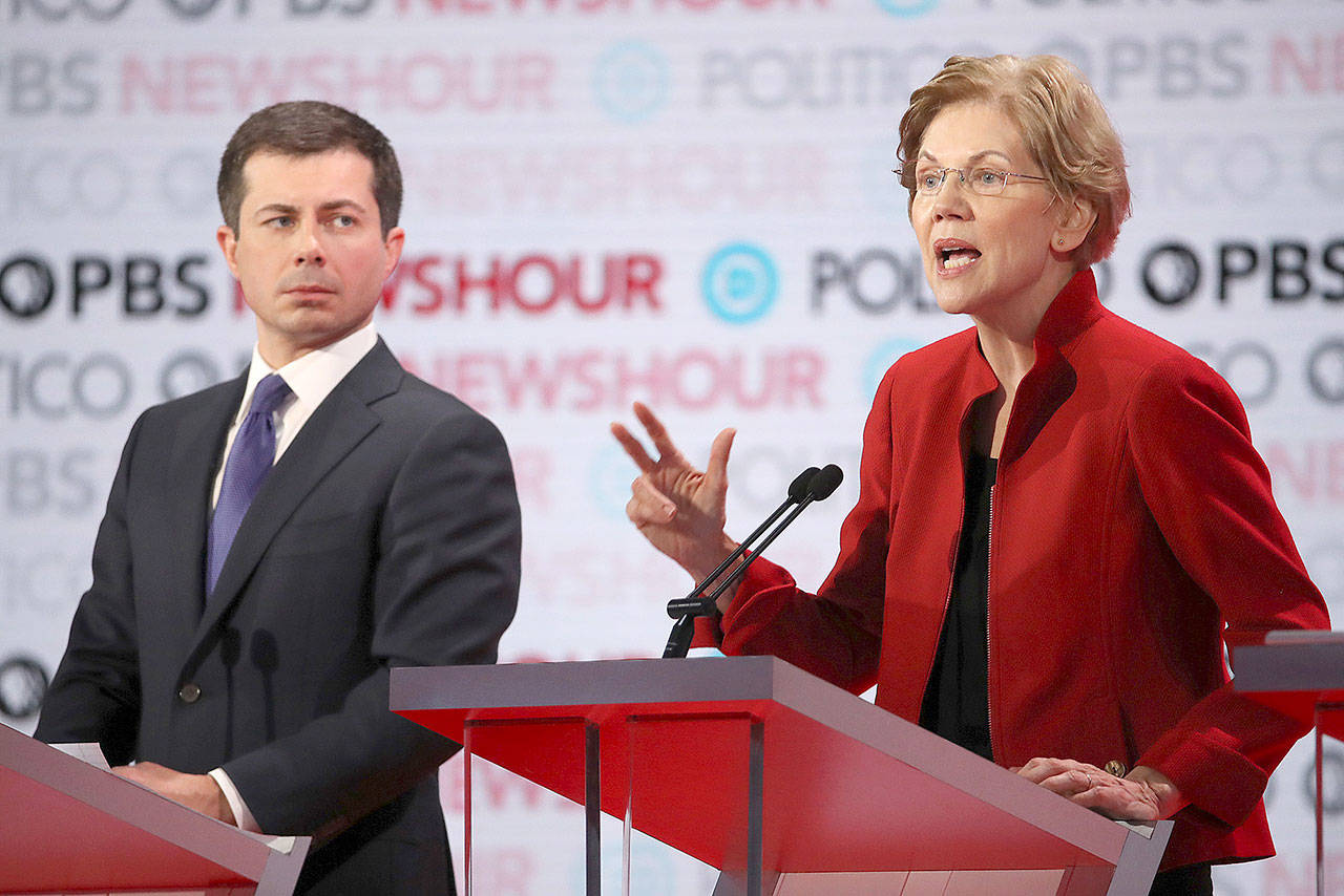 Sen. Elizabeth Warren speaks as South Bend, Indiana Mayor Pete Buttigieg listens during the Democratic presidential primary debate at Loyola Marymount University on Dec. 19 in Los Angeles. Buttigieg was met with criticism during the debate for holding a fundraiser with in a billionaire’s wine cave. (Justin Sullivan/Getty Images)