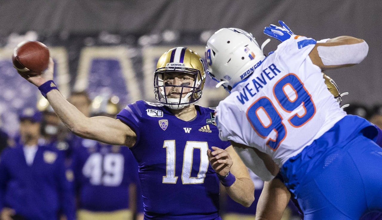 Washington quarterback Jacob Eason (10) passes around the pass rush of Boise State’s Curtis Weaver (99), completing in a touchdown pass in the first quarter in the Las Vegas Bowl on Saturday, Dec. 21 at Sam Boyd Stadium in Las Vegas. Eason announced on Thursday he will enter the 2020 NFL Draft. (Darin Oswald | Idaho Statesman/TNS)