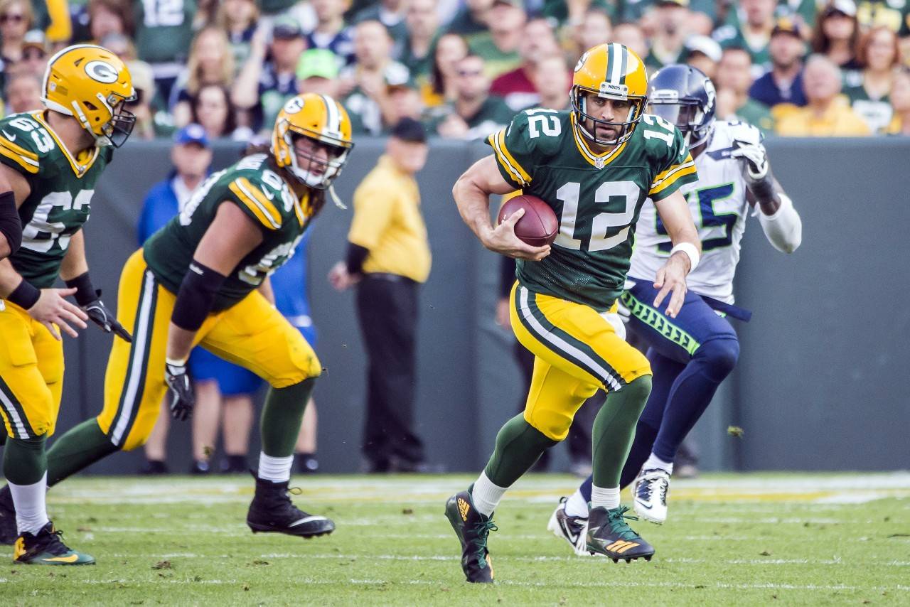 Green Bay Packers quarterback Aaron Rodgers scrambles for a first down in the third quarter against the Seattle Seahawks on Sunday, Sept. 10, 2017 at Lambeau Field in Green Bay, Wisconsin. (Bettina Hansen | Seattle Times/TNS)