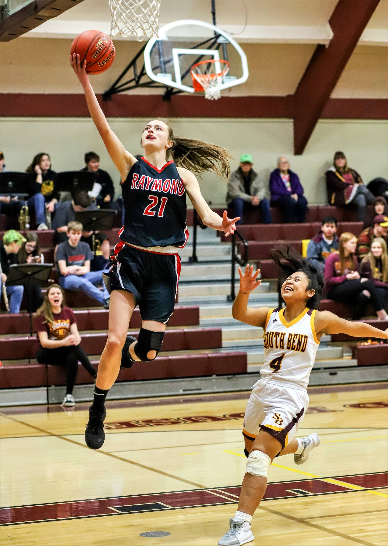 Raymond sophomore Kyra Gardner glides to the basket while South Bend’s Zaira Medina looks on in Raymond’s 50-13 victory on Thursday in South Bend. Gardner scored a game-high 27 points in the contest. (Photo by Larry Bale)