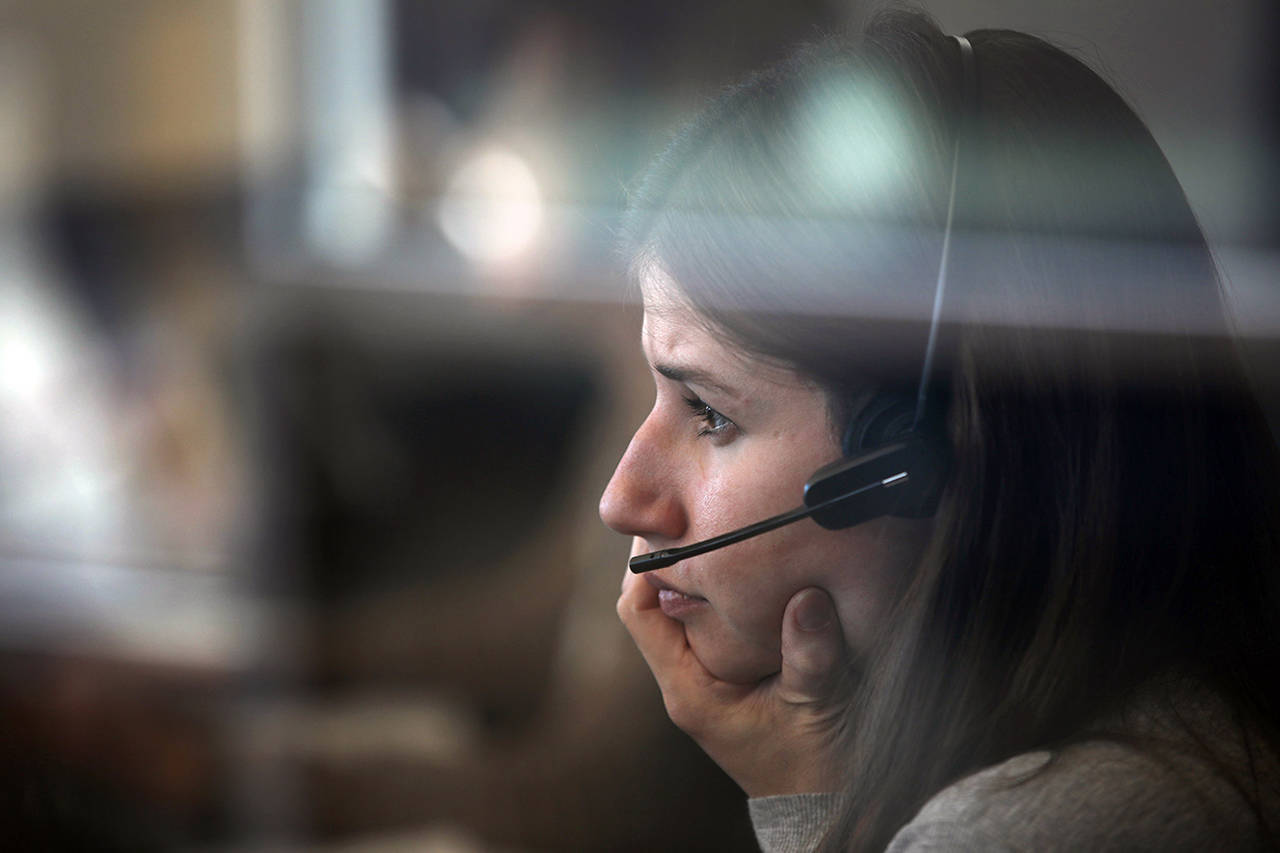 Stacey Wescott | Chicago Tribune                                Kathryn Haeffner, an emergency service counselor, provides guidance during a follow-up call at the crisis call center in the DuPage County Health Department in Wheaton, Illinois.