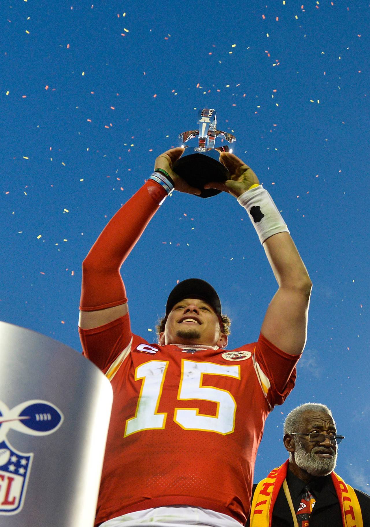Kansas City Chiefs quarterback Patrick Mahomes hoists the Lamar Hunt AFC Championship trophy over his head after the Chiefs defeated the Tennessee Titans 35-24 to take the title and earn a trip to the Super Bowl after the AFC championship game on Sunday at Arrowhead Stadium in Kansas City, Missouri. (Jill Toyoshiba | Kansas City Star/TNS)