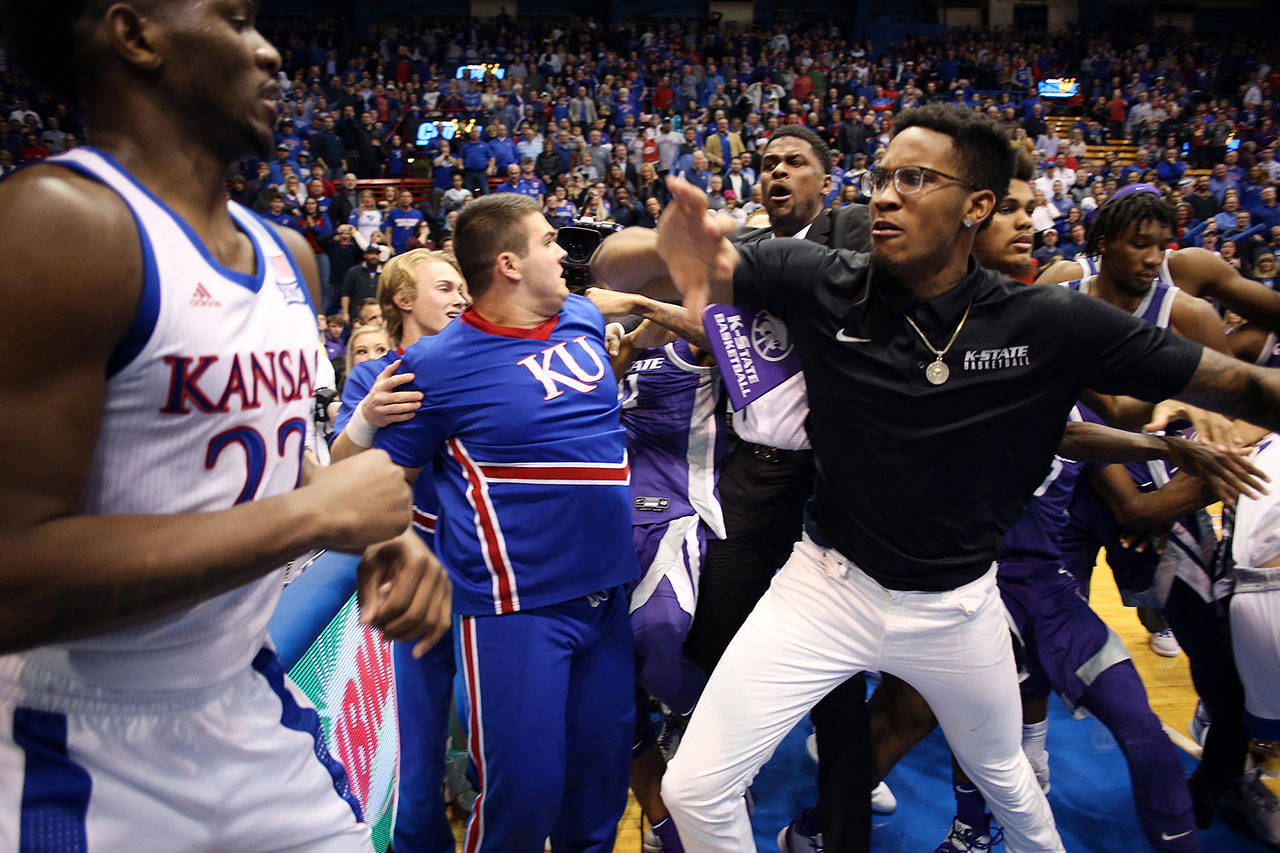 Silvio De Sousa (22) of the Kansas Jayhawks and James Love III of the Kansas State Wildcats participate in a brawl after the game at Allen Fieldhouse on Jan. 21, 2020 in Lawrence, Kan. De Sousa has been suspended indefinitely by Kansas coach Bill Self. (Jamie Squire/Getty Images/TNS)                                Silvio De Sousa (22) of the Kansas Jayhawks and James Love III of the Kansas State Wildcats participate in a brawl after the game at Allen Fieldhouse on Jan. 21, 2020 in Lawrence, Kan. De Sousa has been suspended indefinitely by Kansas coach Bill Self. (Jamie Squire/Getty Images/TNS)