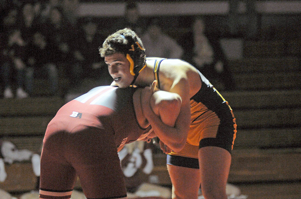 Aberdeen wrestler Liam Heikkila, right, works to gain control of Hoquiam’s Thomas Goulet during a 195-pound match in Friday’s dual meet at Hoquiam High School. (Ryan Sparks | Grays Harbor News Group)