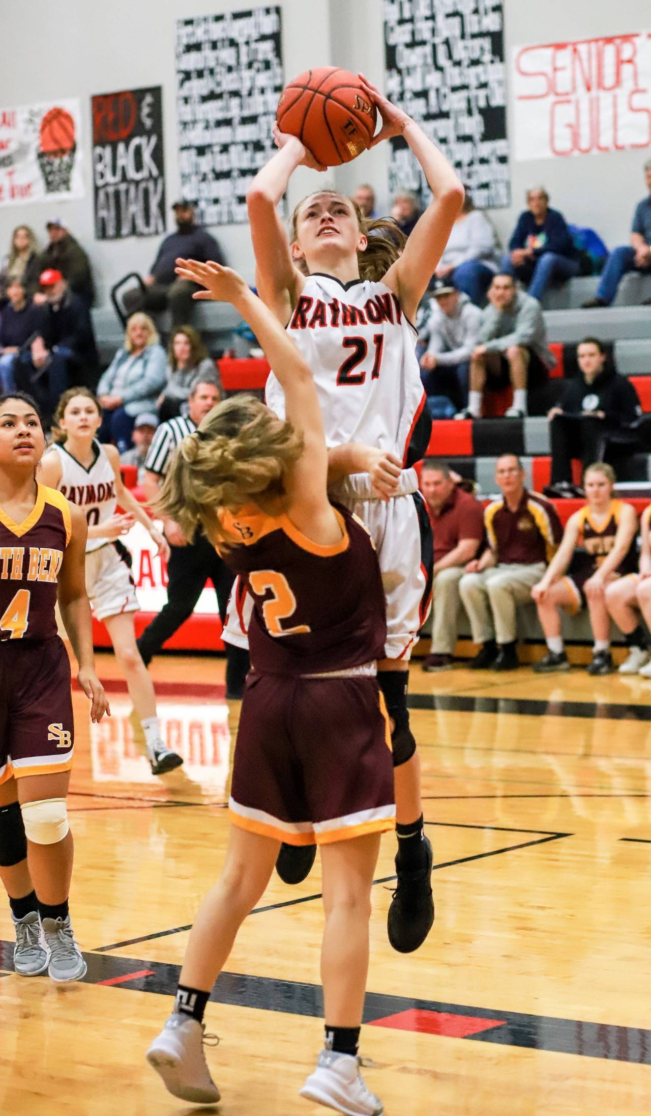 Raymond’s Kyra Gardner (21) puts up a shot against South Bend’s Elli Capps during Raymond’s 59-20 win on Wednesday at Raymond High School. Gardner led all scorers with 22 points. (Photo by Larry Bale)