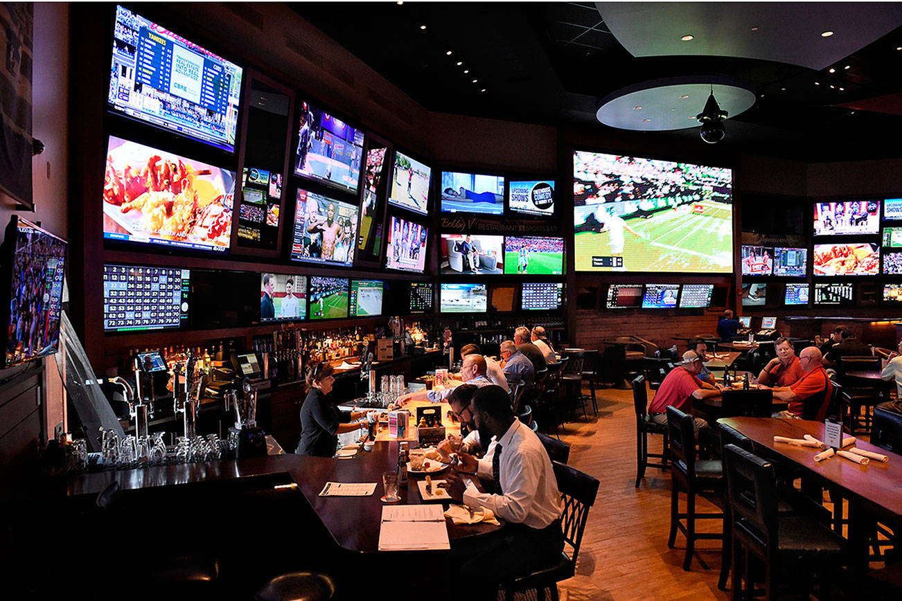 Patrons fill the bar and tables at Bobby V’s, a sports bar at the Bradley Teletheater, an off-track betting venue in Windsor Locks, Connecticut. Scenes such as this could be coming to Washington state within the year as a House appropriations committee voted to forward sports gambling bill HB 2638 to a possible full floor vote. (Tribune News Service)