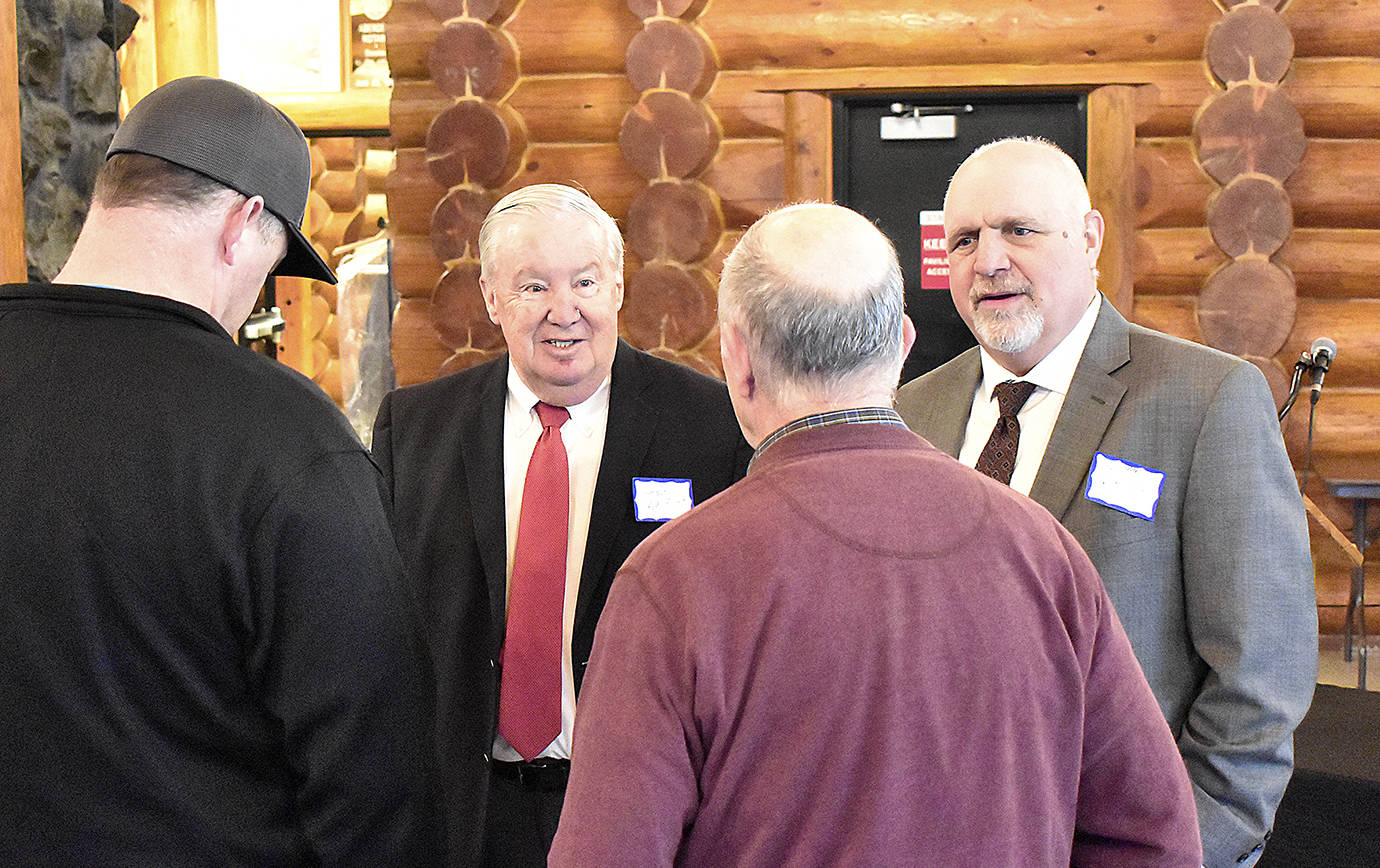DAN HAMMOCK | GRAYS HARBOR NEWS GROUP                                 Port of Grays Harbor Commissioners Stan Pinnick, left, and Phil Papac chat with guests at the Port’s annual business report breakfast at the Rotary Log Pavilion in Aberdeen Wednesday.