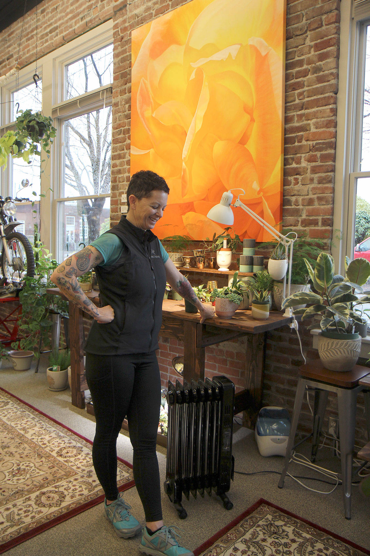 Trena Moore pauses while discussing her work Jan. 29, 2020, at her gallery, The Moore Gallery, in Montesano. The painting behind her recently sold for $5,400. (Michael Lang | Grays Harbor News Group.)
