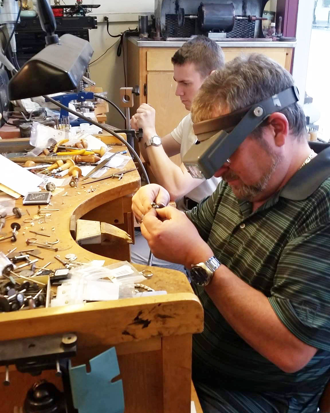 Mike Giron and son Taylor Parson repair watches and jewelry at Wiitamaki Jewelry Store, carrying on the family business started by Giron’s grandparents in 1926.