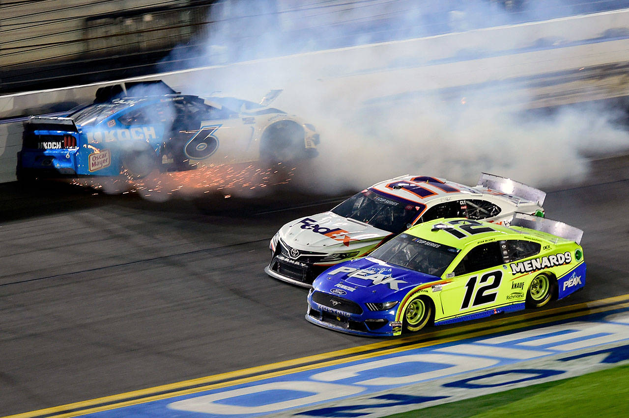 Denny Hamlin, driver of the No. 11 FedEx Express Toyota, and Ryan Blaney (12) race to the finish as Ryan Newman (6) wrecks on the last lap of the NASCAR Cup Series 62nd Annual Daytona 500 at Daytona International Speedway on Monday in Daytona Beach, Fla. (Jared C. Tilton/Getty Images/TNS)