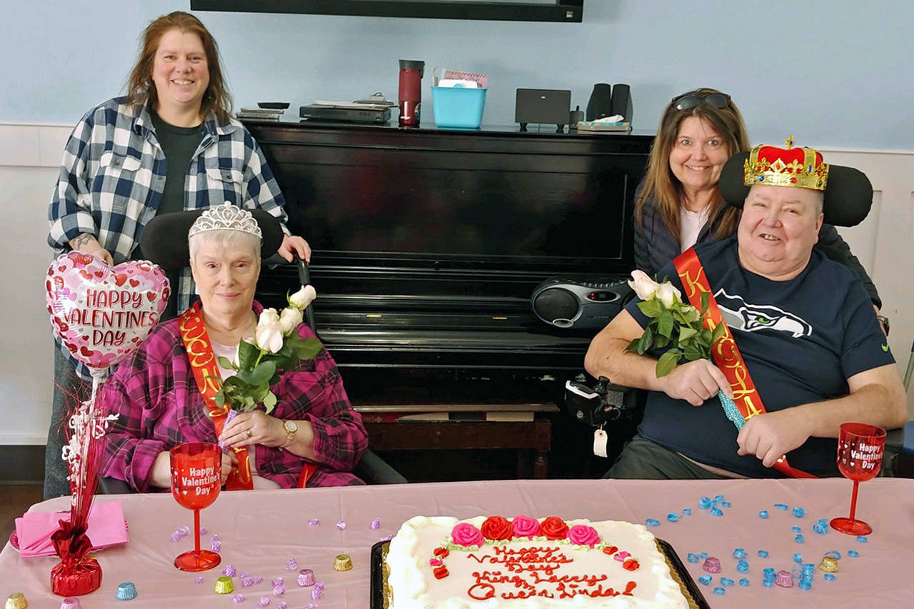 Courtesy photo                                Each February, Pacific Care staff members vote for residents to be honored as Valentine king and queen. Then, during the Hoquiam facility’s annual Valentine’s Day party, the royals are celebrated with crowns, flowers, punch and cake. This year’s queen is resident council president Linda Gladson (left, with daughter Kristine Gladson is standing behind her). The king is resident council vice president Larry Schoening (whose sister Tammie Jacobs is standing behind him).