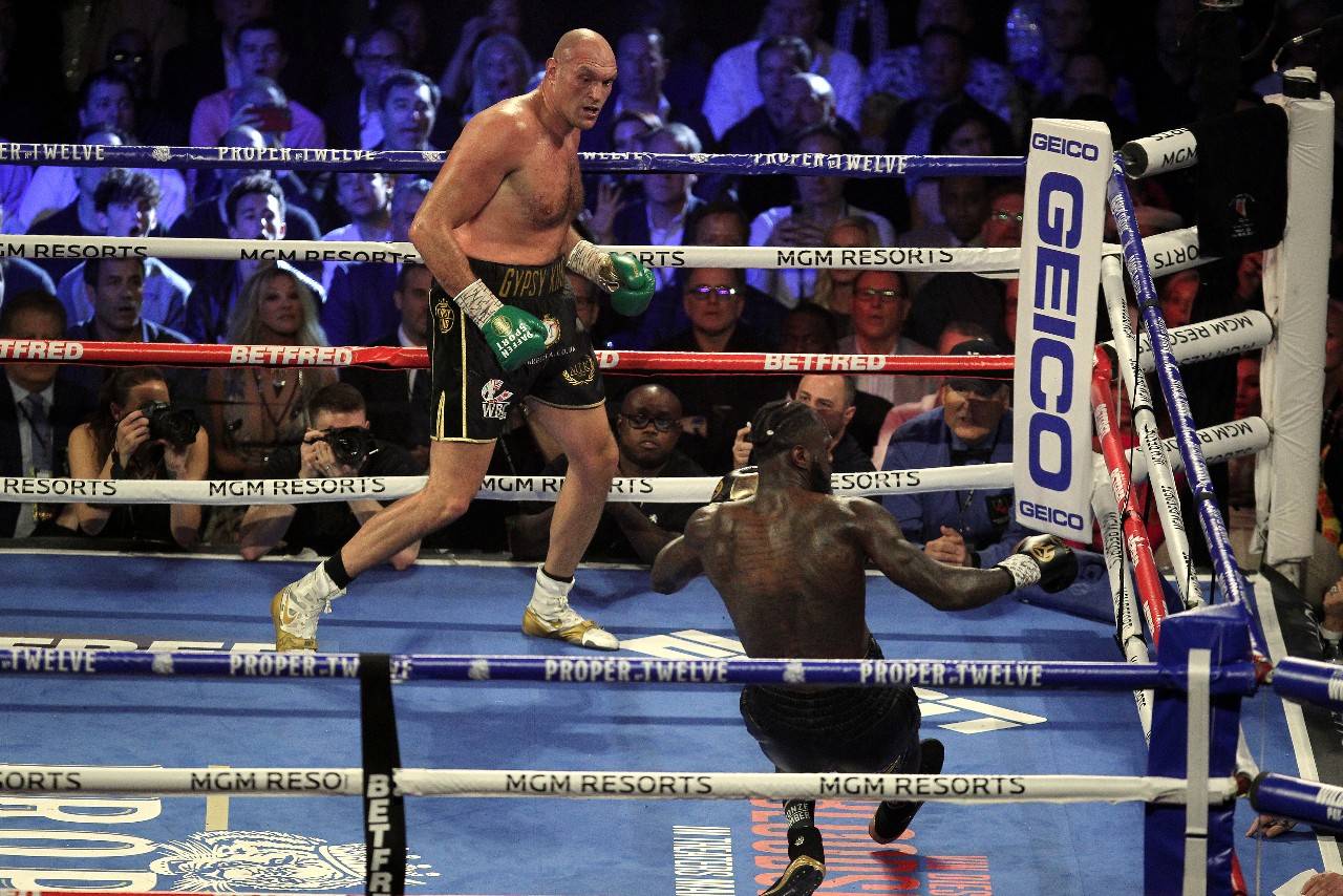 Tyson Fury, left, stops Deontay Wilder in their rematch to win the WBC World Heavyweight Championship at the MGM Grand Garden Arena in Las Vegas on Saturday. Fury knocked down Wilder in the third and fifth rounds before Wilder’s corner threw in the towel during the seventh round as referee Kenny Bayless stopped the fight. (Chris Farina | ZUMA Wire)