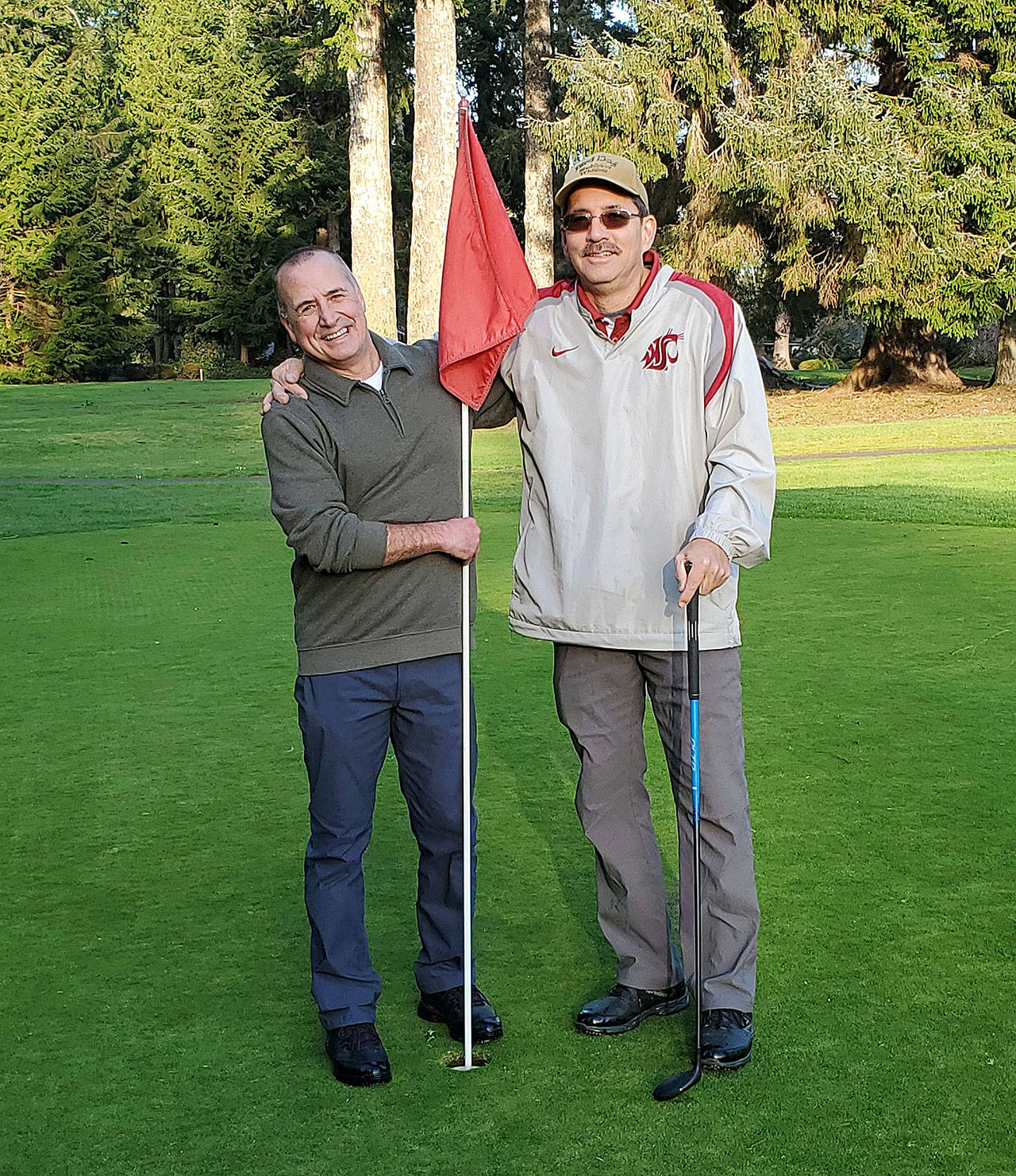 Ed Patrick, right, stands with Lee Gochnour after Patrick recorded an ace on the No. 4 hole at Grays Harbor Country Club on Sunday, Feb. 9. (Submitted photo)