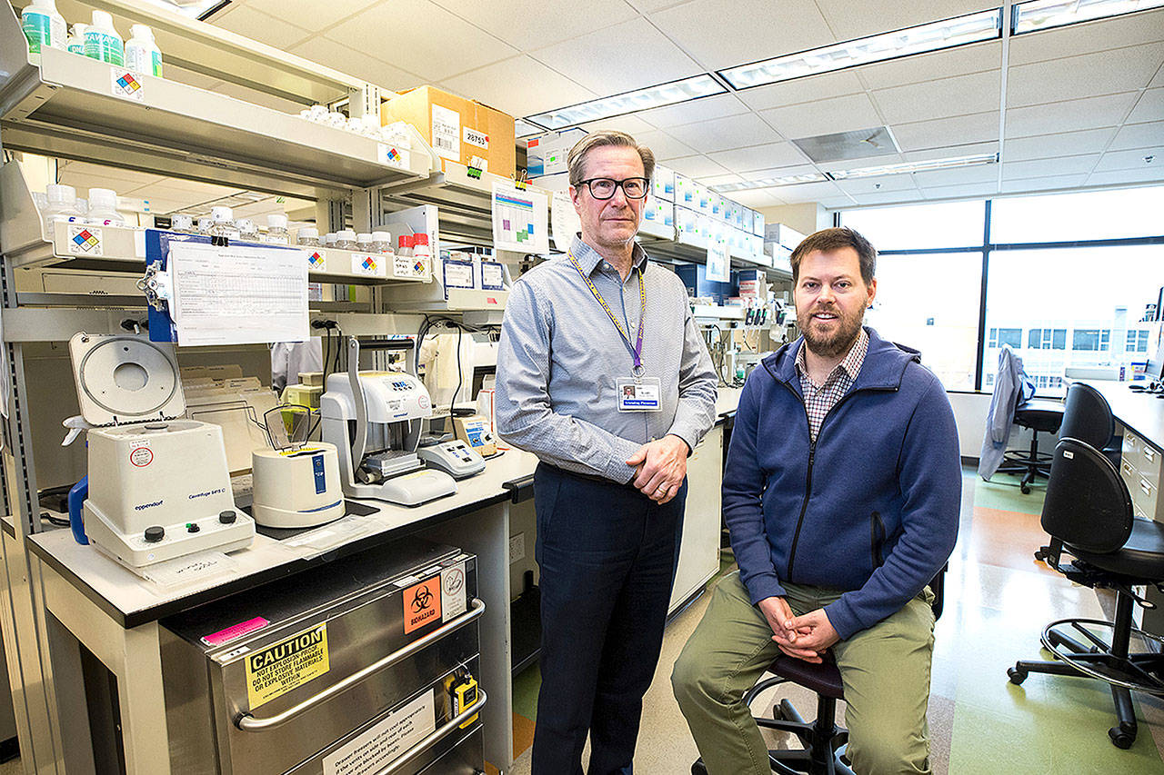 Dr. Keith Jerome, left, director of the UW Medicine Virology laboratory in Seattle, and Dr. Alex Greninger, assistant director of the lab, quickly ramped up a test to detect the novel coronavirus, SARS-CoV-2. As of March 11, their lab had performed nearly 3,000 tests, with nearly 270 found to be positive. (Dan DeLong/Kaiser Health News)