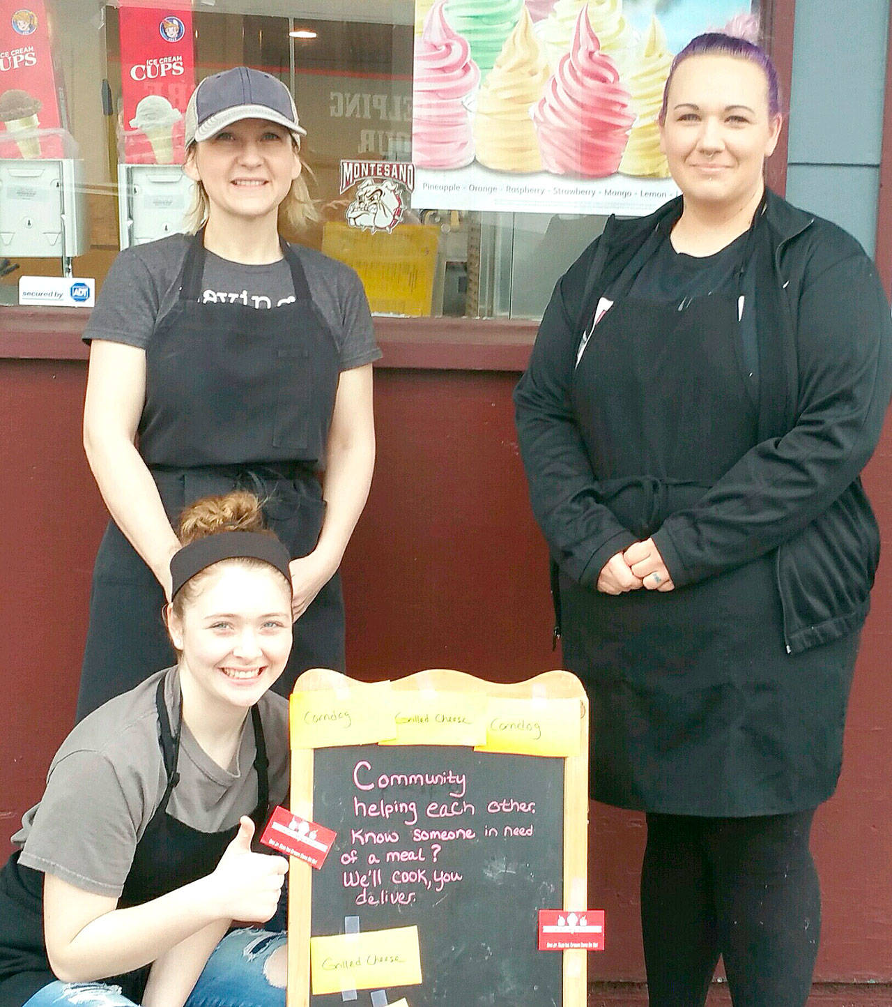 Asher Holcomb photo                                Gene’s Stop & Go owner/operator Ginger Holcomb, standing at left, has set up a voucher board to give her customers a way to help their neighbors in need. She’s pictured here with her crew: daughter Macy Holcomb, left, and Stephanie Larsson.