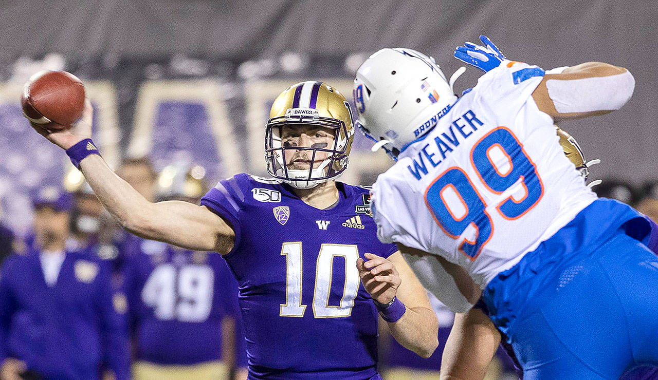 Washington quarterback Jacob Eason throw around the pass rush of Boise State’s Curtis Weaverfor a touchdown pass in the first quarter in the Las Vegas Bowl on Saturday, Dec. 21, 2019. CBSSports has Eason rated as the No. 4 quarterback and the No. 41 player overall in the upcoming NFL Draft. Eason was one of 58 players — and the only UW player — invited to participate in the NFL Draft’s virtual event. (Darin Oswald/Idaho Statesman)