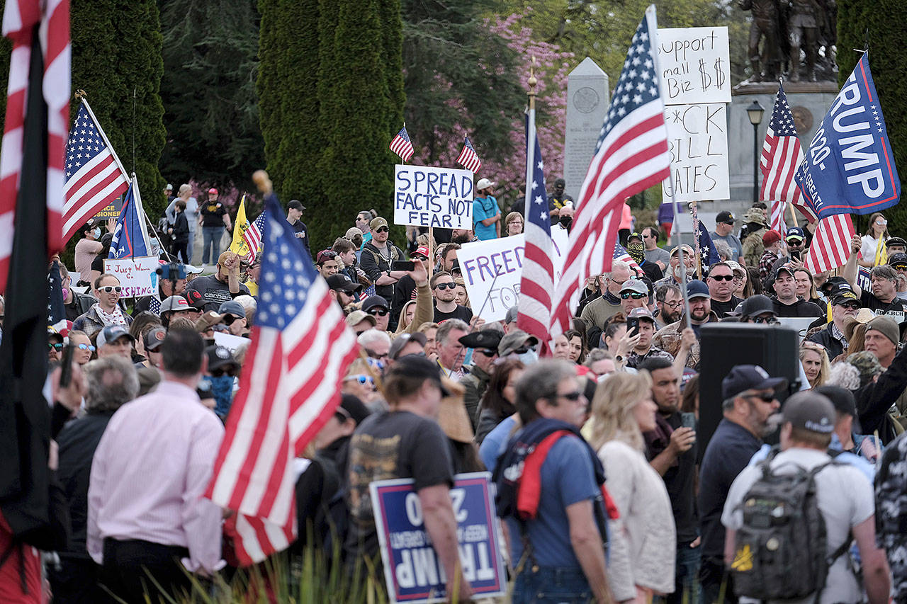 Hundreds of protesters gather around the Capitol in Olympia on Sunday to demonstrate against Gov. Inslee’s stay-home order, which is in effect through May 4. (Photo by Alex Milan Tracy/Sipa USA)