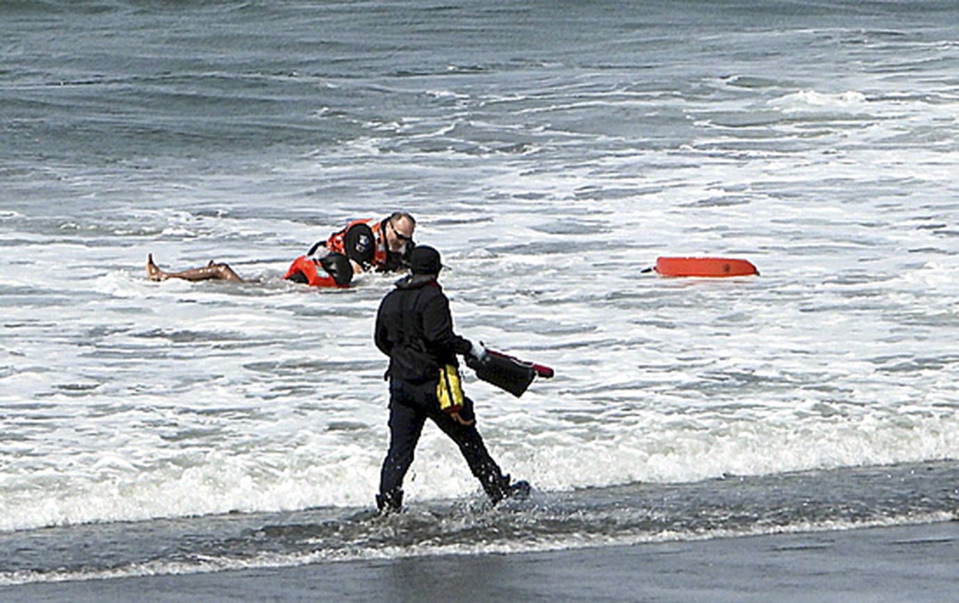SKIP RADCLIFFE PHOTO                                 Ocean Shores Police Department personnel bring one of two kayakers out of the surf near the North Jetty Thursday, April 30.