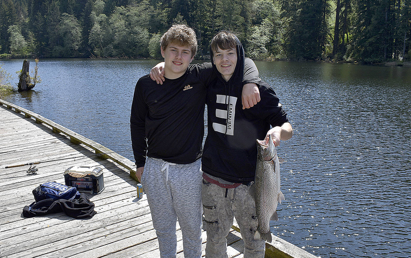 photos by DAN HAMMOCK | GRAYS HARBOR NEWS GROUP                                 Anthony Blevins, of Montesano, left, and David Reinkens, of Westport, show off the big rainbow trout Reinkens caught out of Lake Sylvia Tuesday morning.